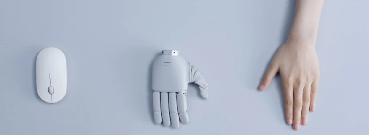 OmniHand 3 Lite-S beside a computer mouse and a human hand, showing its compact size