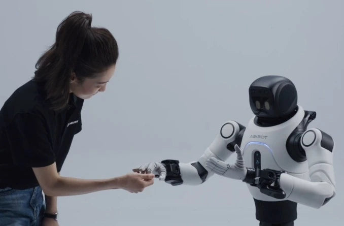 A person interacting with Lite-S on a compact humanoid