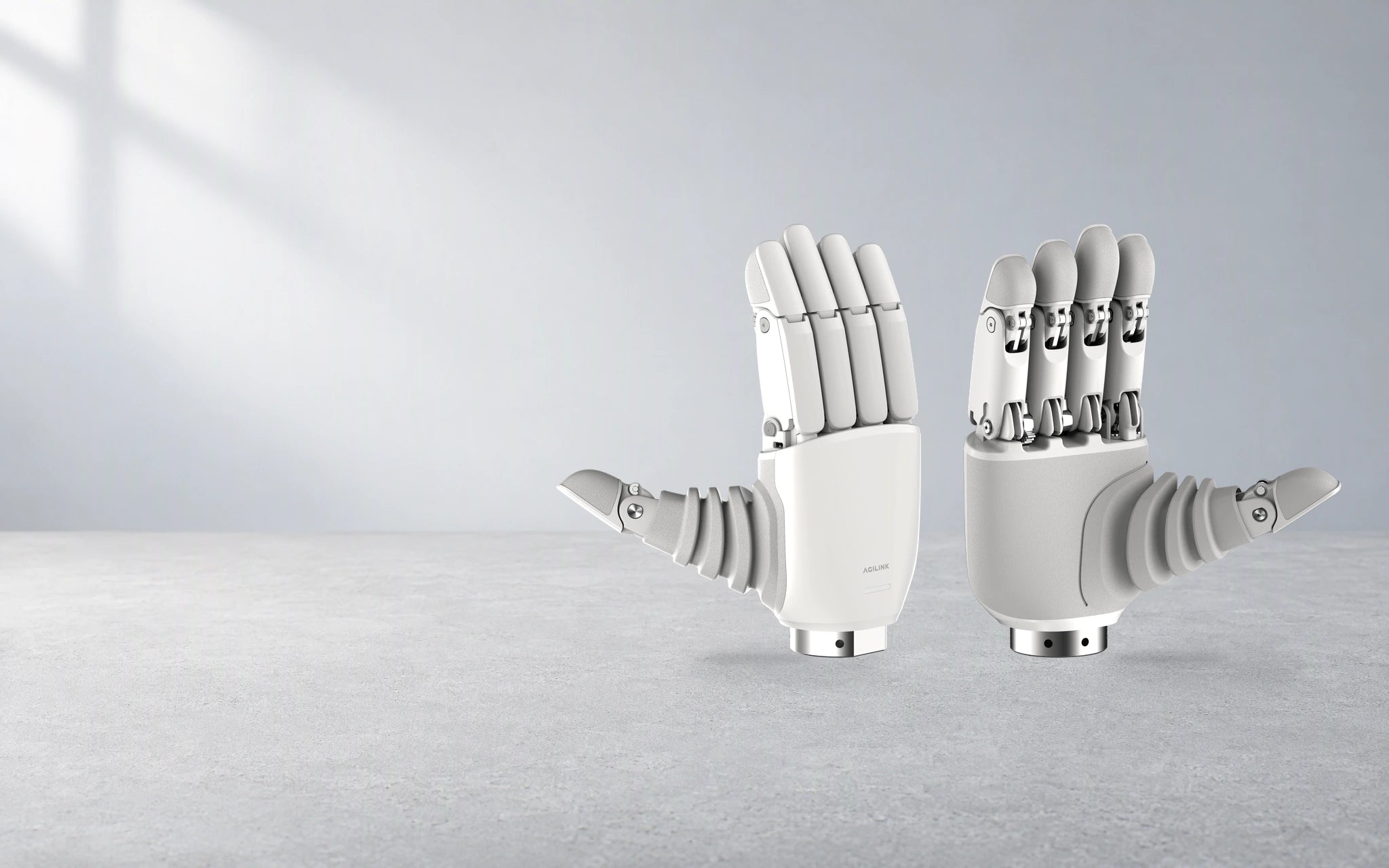 Original Lite-S back and palm views at matching scale, in neutral daylight on a research workbench