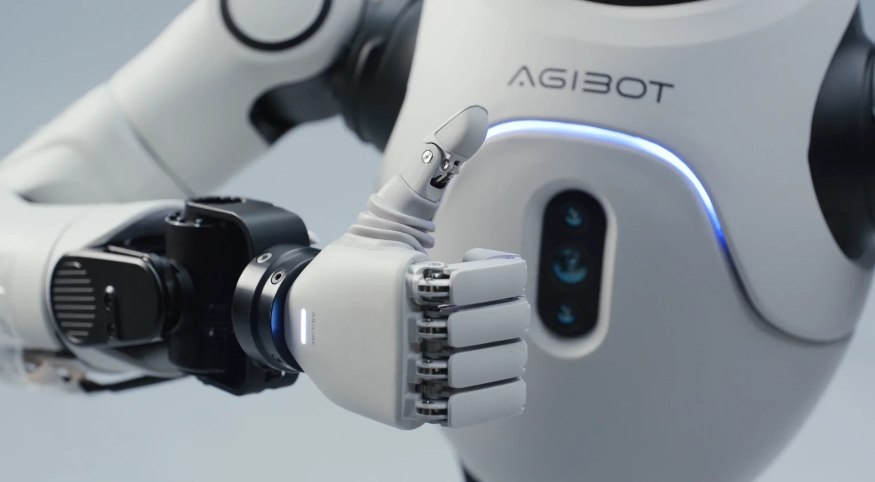 Original Lite-S hand making a thumbs-up beside the robot chest